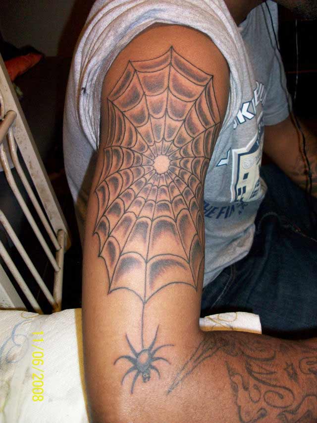 Spider web arm tattoo