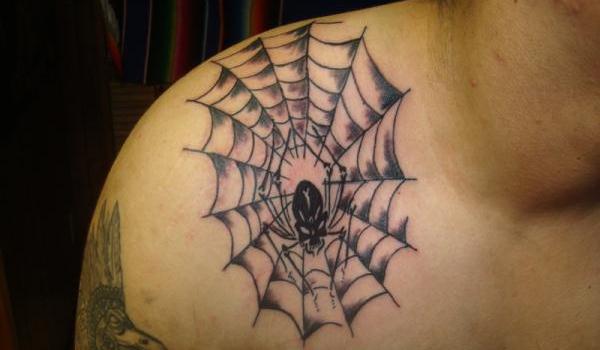 Spider web shoulder tattoo