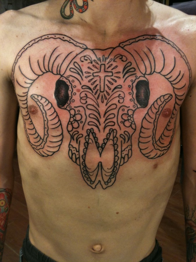 Spooky goat skull chest tattoo