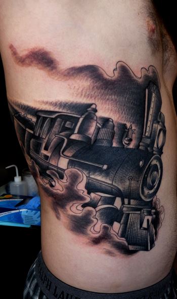 Steaming train side tattoo