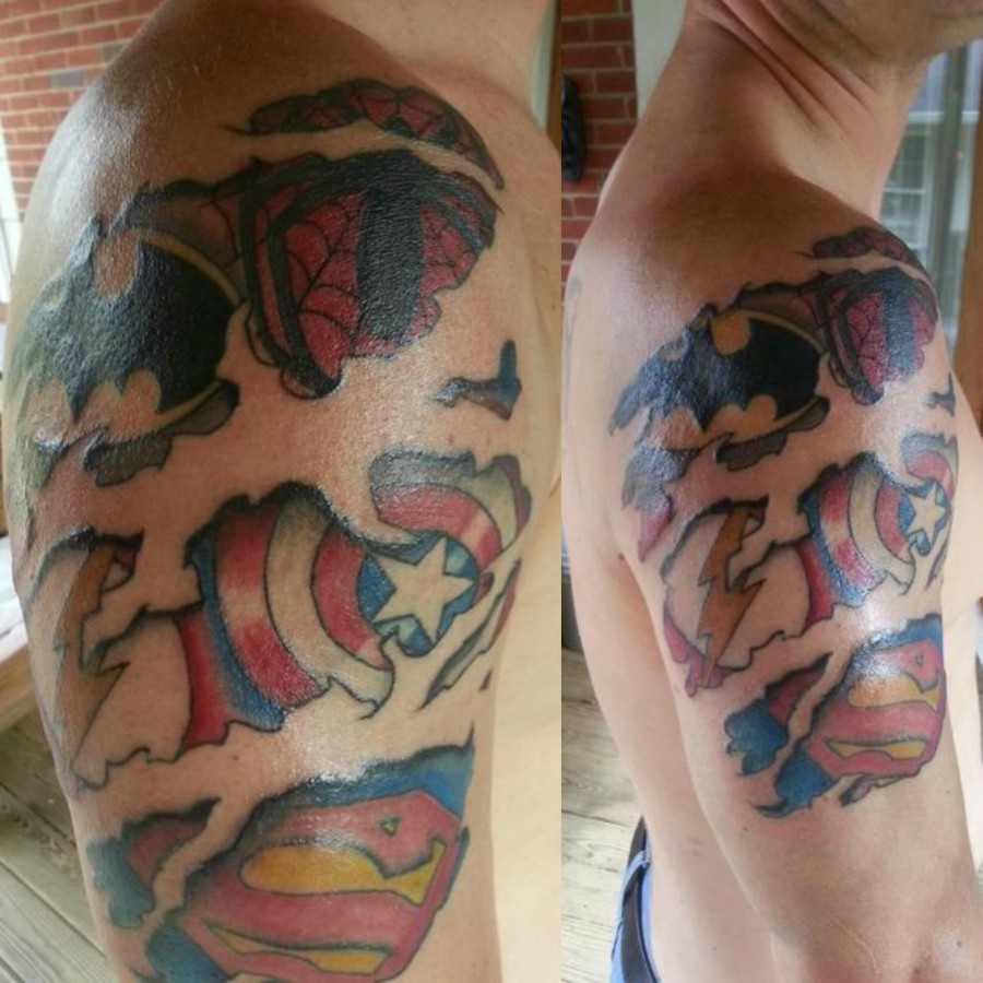 Superhero logos arm tattoo