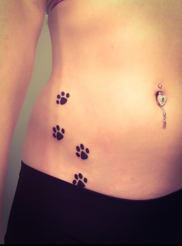 Sweet paw print hip tattoo