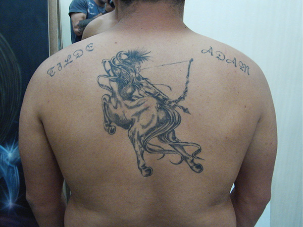 Sweet sagittarius back tattoo