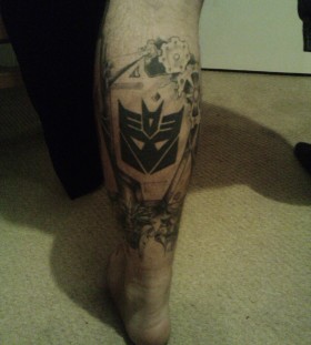 Sweet transformers logo leg tattoo