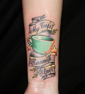 Teacup and writing tattoo