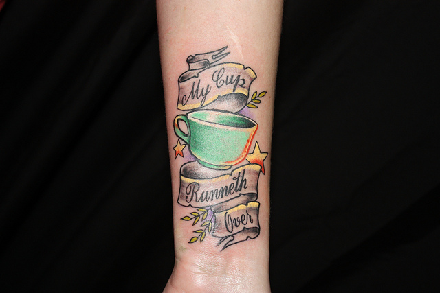 Teacup and writing tattoo