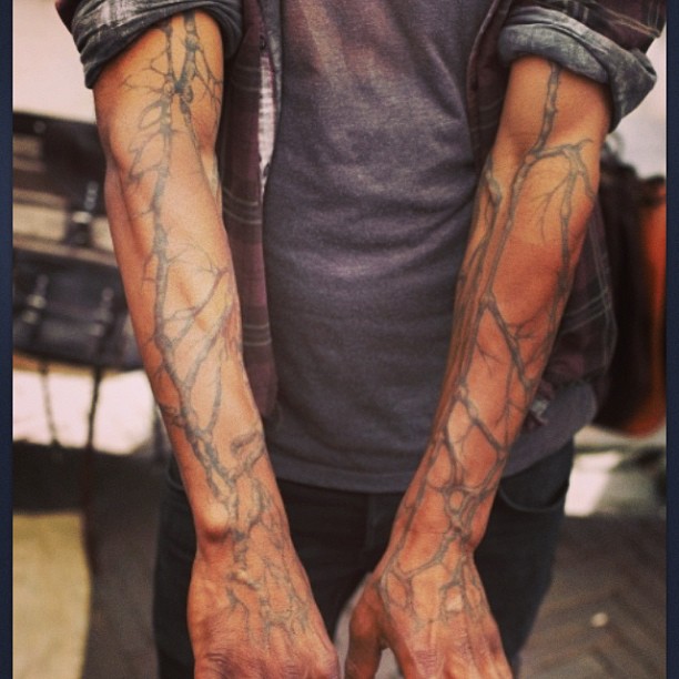 Tree branch full arm tattoo