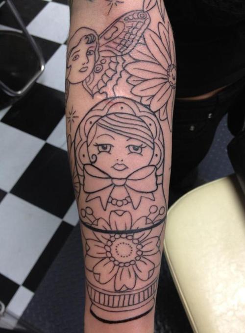 Uncoloured matryoshka arm tattoo