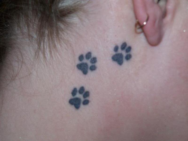 Upper neck paw tattoo