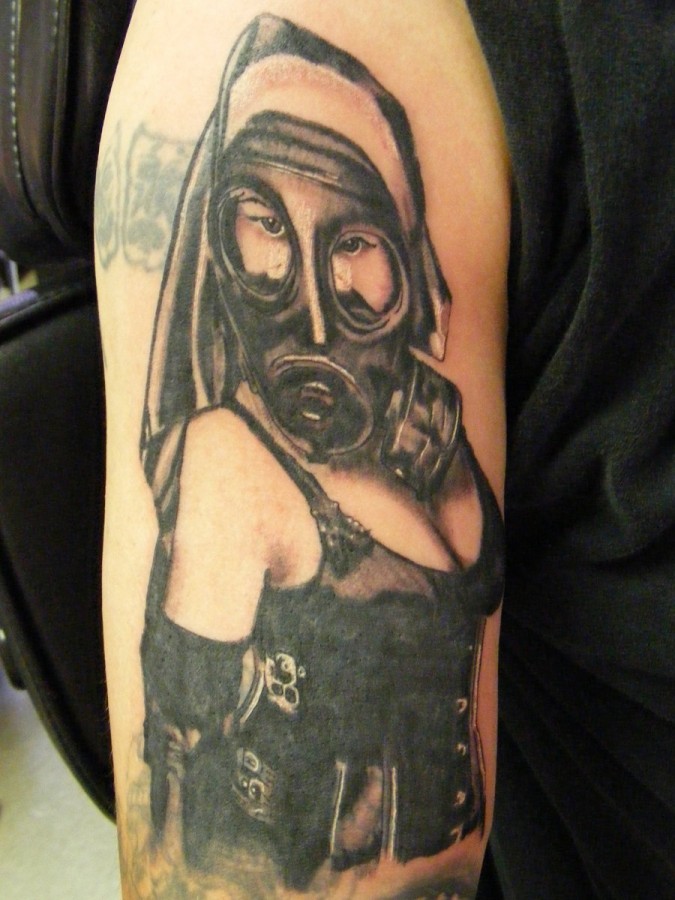 Woman with gas mask arm tattoo