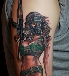 Woman with gun and gas mask tattoo