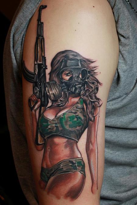 Woman with gun and gas mask tattoo