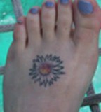 Cute Tiny Aster Flower Tattoo Design on Foot