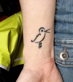 Tiny Bird Tattoo On Wrist