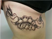 Brass Knuckle Tattoo on Woman’s Rib