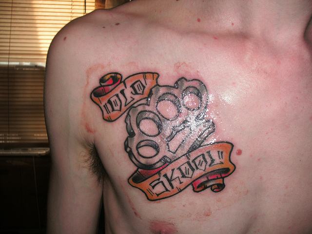 Brass Knuckles Tattoo on Chest