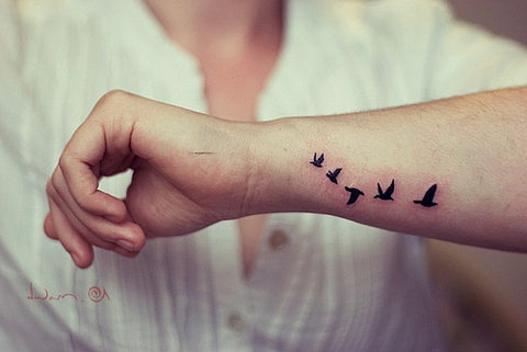 Design Of Flying Bird Silhouette Tattoo On Arm