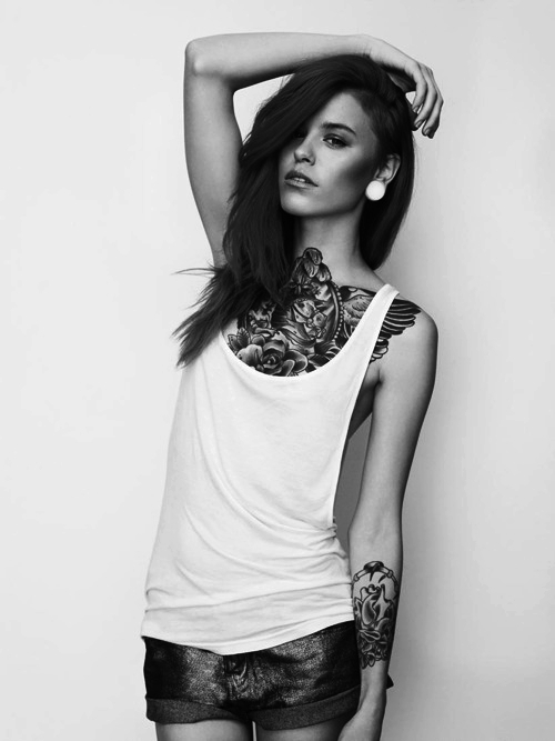 Girl With Tattoos In her Chest And Forearm