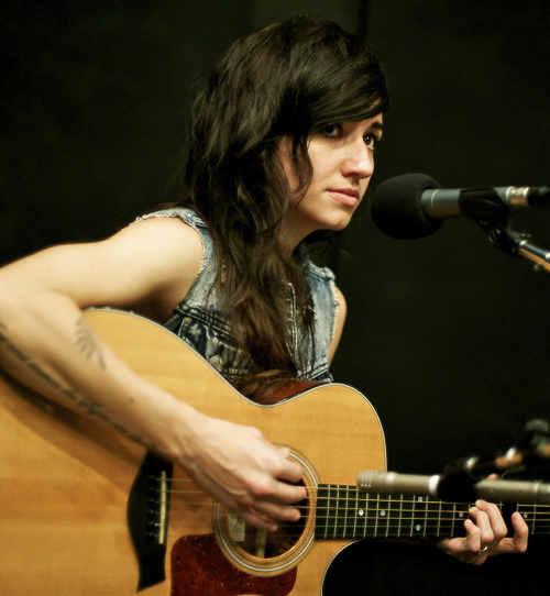 Exotic Lights Poxleitner Tattoos Holding a Guitar