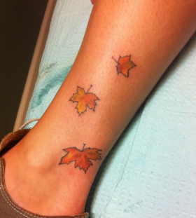 maple-leaves-on-leg-tattoo maple-leaves-on-leg-tattoo