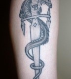 Dragon Wrapped Around A Dagger Tattoo