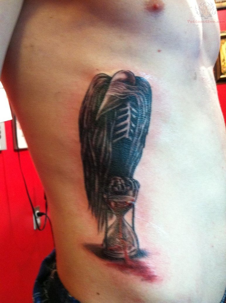 Cool Hourglass And Crow Tattoo On Rib