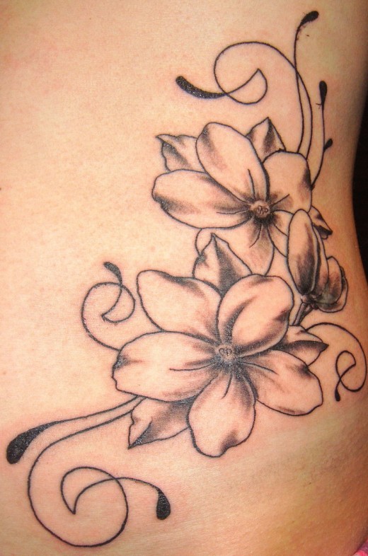 Flower And Swirls Tattoo On Ribs