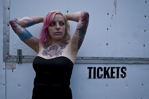 Cute Woman with Tattoo on Neck and Arm