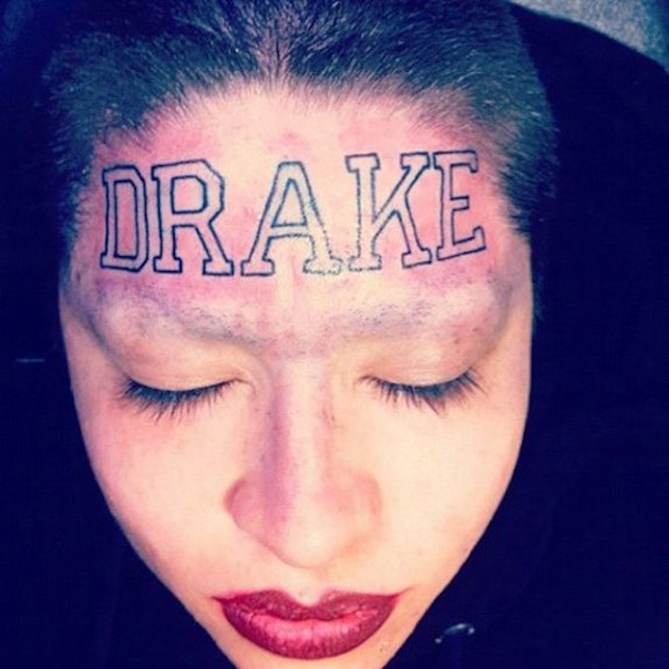 Bold Lettering Name Tattoo on Women Forehead