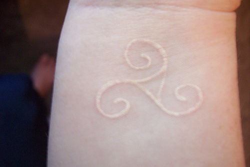 Simple Symbol Tattoo with White Ink